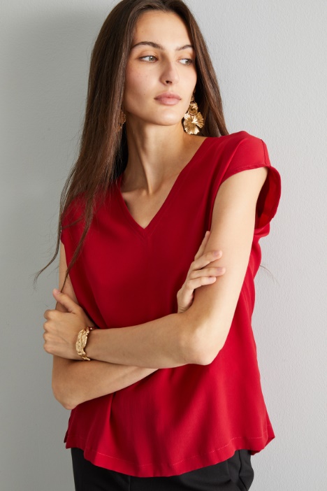 Blusa con maniche ad aletta