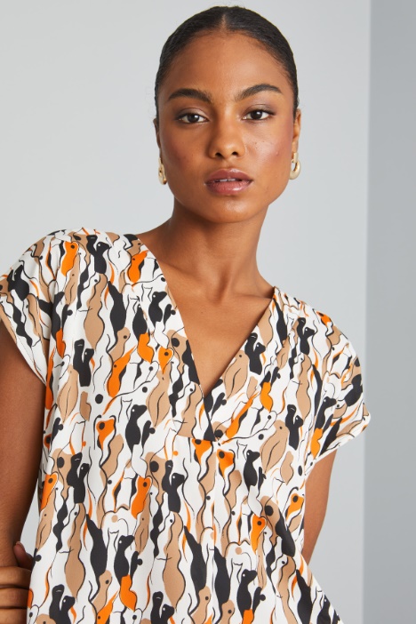 Blusa con maniche ad aletta