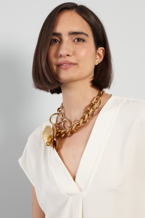 Blusa con piega ribattuta