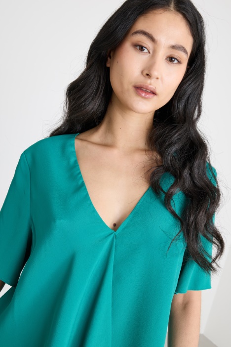 Blusa con volant asimmetrico